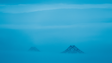 Symbolic photo of tops of Golden Gate Bridge peaking above the dense fog.